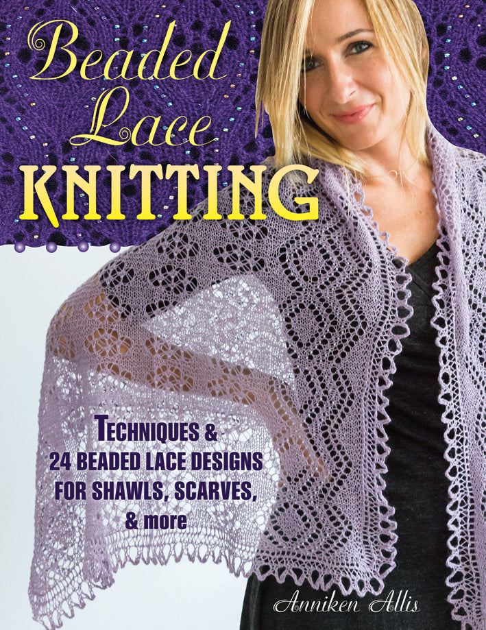 The front cover of "Beaded Lace Knitting" by Anniken Allis featuring a woman wearing a handmade lace knitted shawl ontop of a picture of a purple piece of beaded lace.
